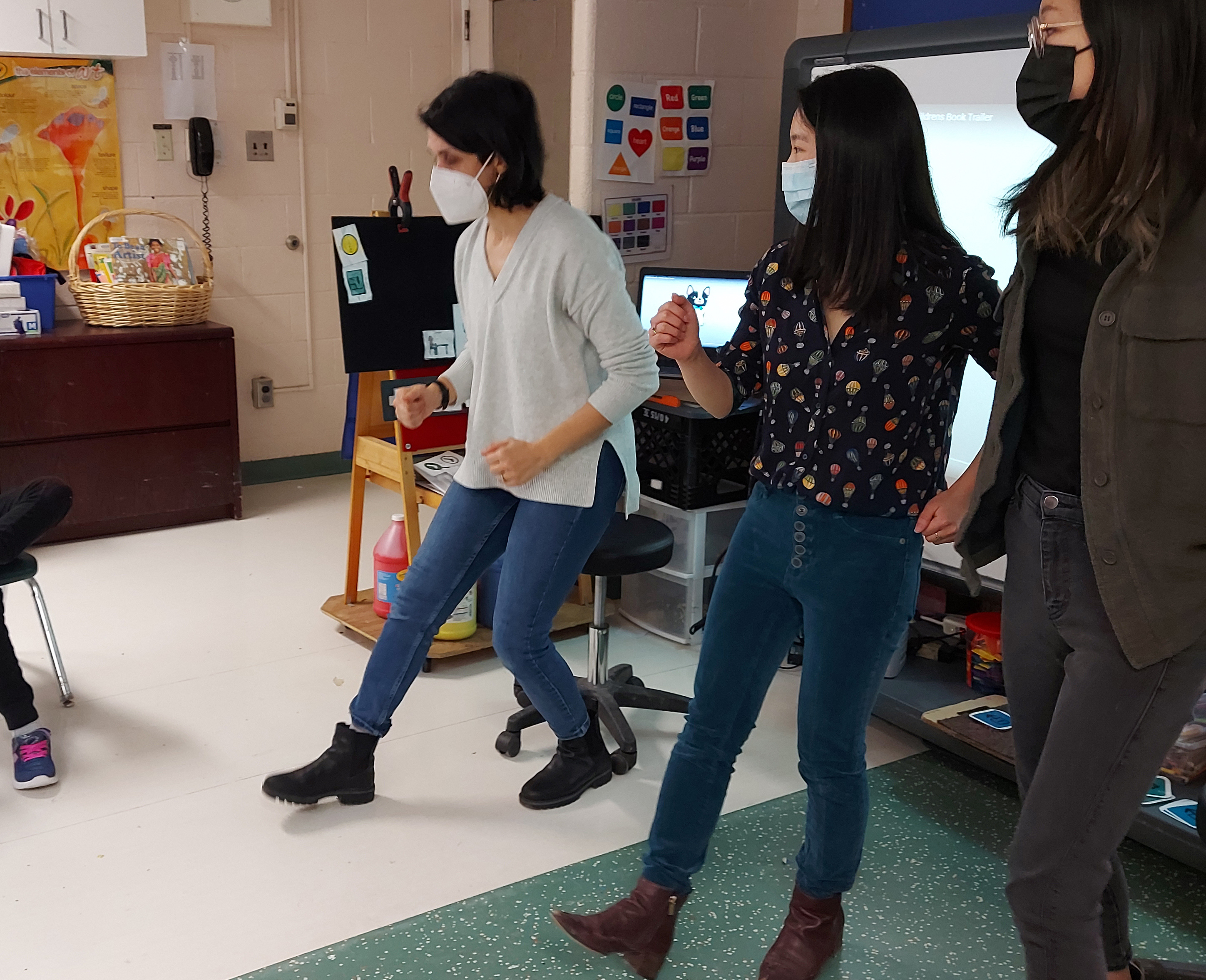 3 facilitators are showing a movement